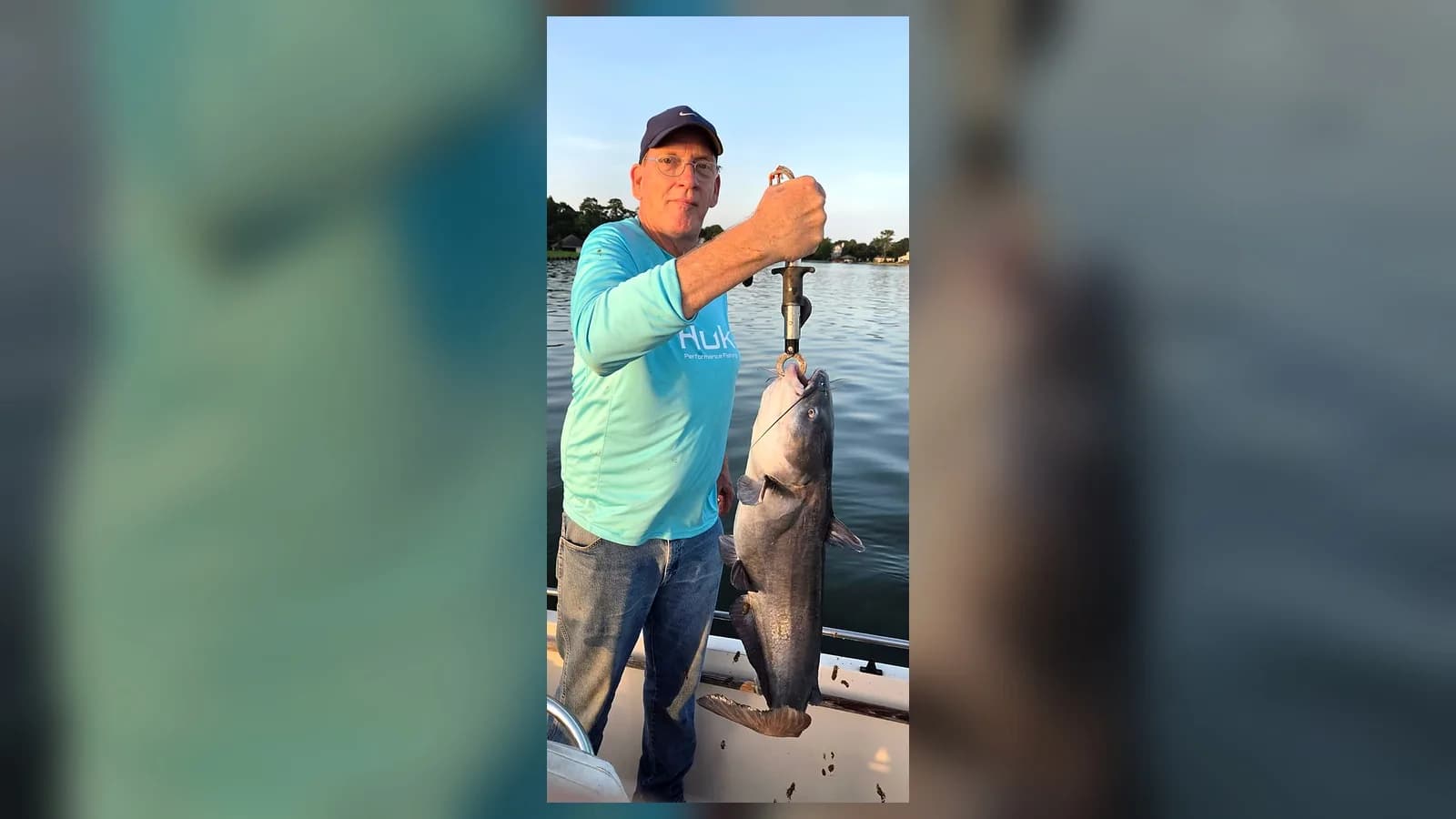 Steven holds a large Lake Conroe catfish from a boat during warm evening light