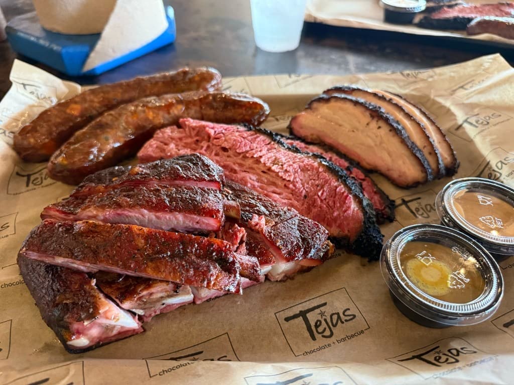 Tejas Chocolate + Barbecue tray with brisket, ribs, sausage, and turkey in Tomball, Texas